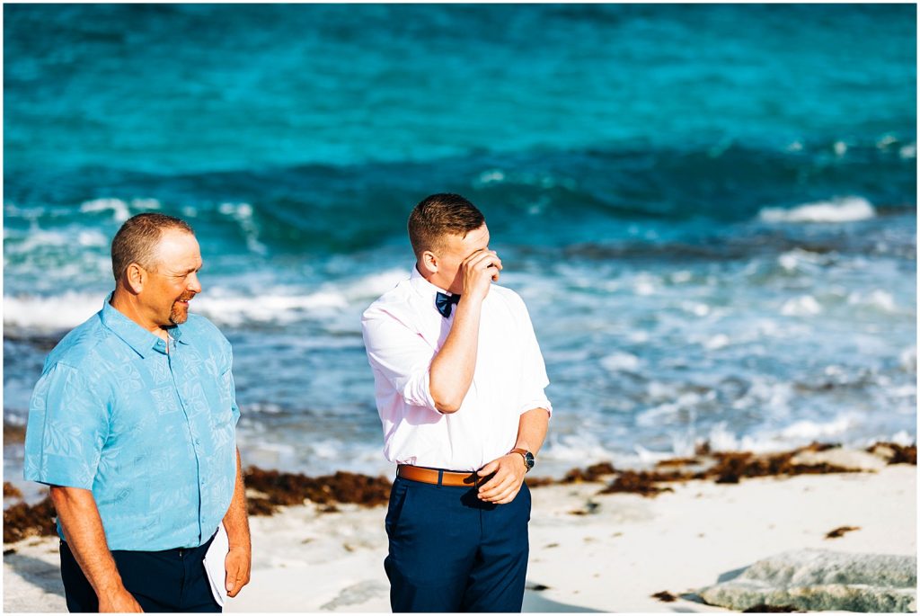 groom reacting to seeing his bride during beachfront ceremony in the bahamas