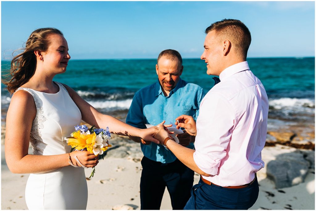 bride and groom exchange rings on green turtle cay