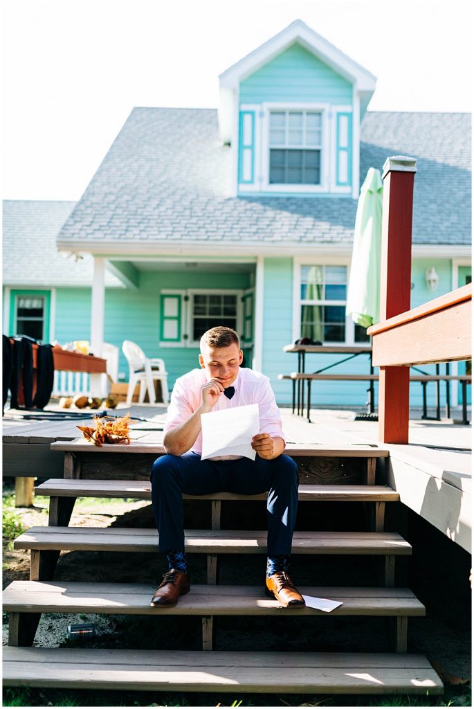 groom reading letter from his bride at a beach house in the caribbean